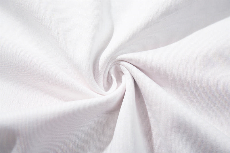 White knit fabric with a soft spiral fold, showcasing the texture of a varsity raglan streetwear tee