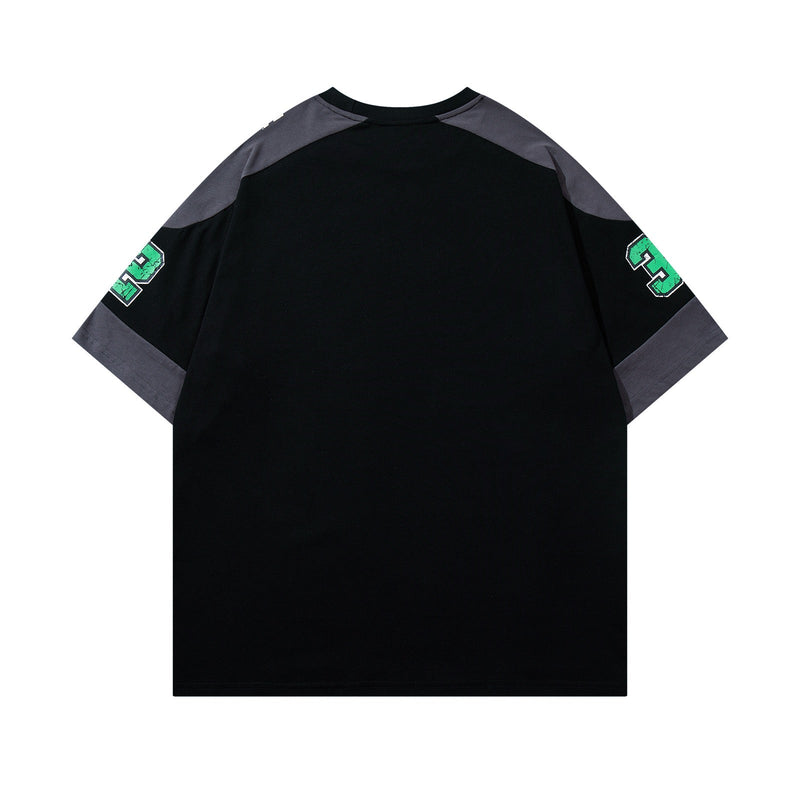 Black varsity graphic tee with gray contrast shoulder panels and green number prints on the sleeves, shown flat-lay
