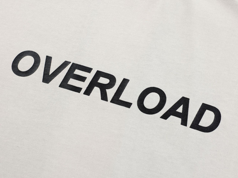 Close-up of a white Seakoff streetwear tee with bold black OVERLOAD logo print across the chest