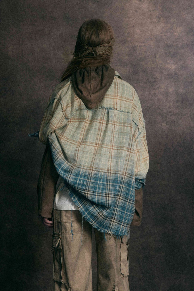 Back view of the plaid flannel shirt with brown hooded layer underneath