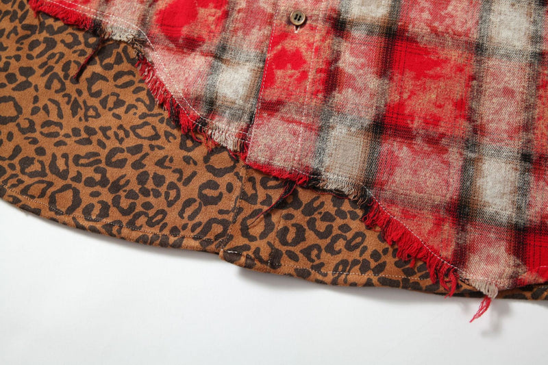 Close-up of leopard print hem on red plaid patchwork shirt