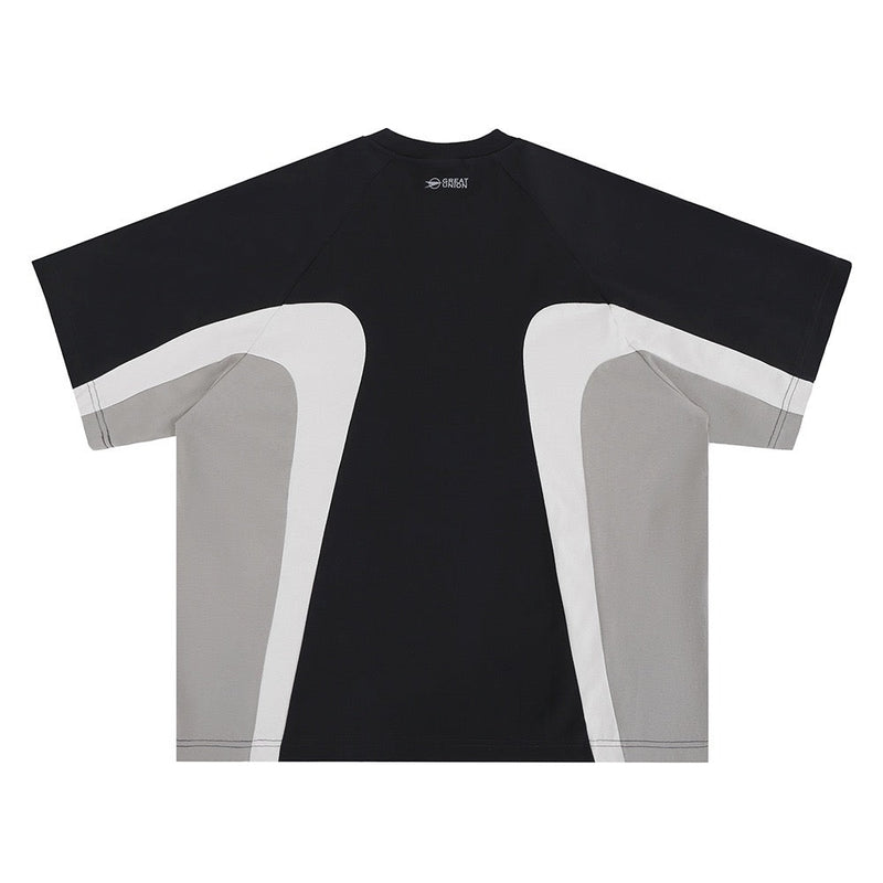 Black colorblock T-shirt with white and gray curved panels, short sleeves, and a futuristic streetwear design