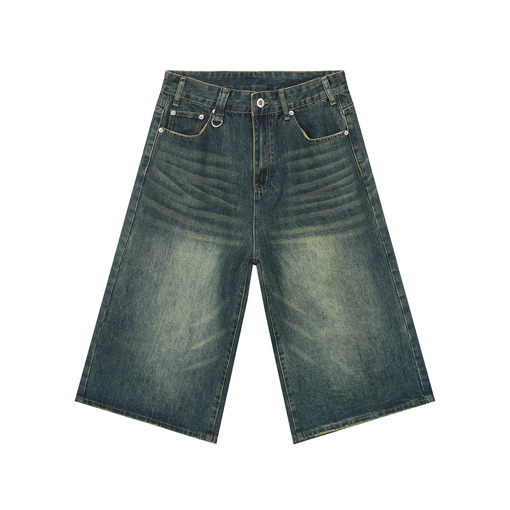Flat lay of wide leg vintage wash denim shorts in faded blue with yellow-green contrast stitching and five-pocket design