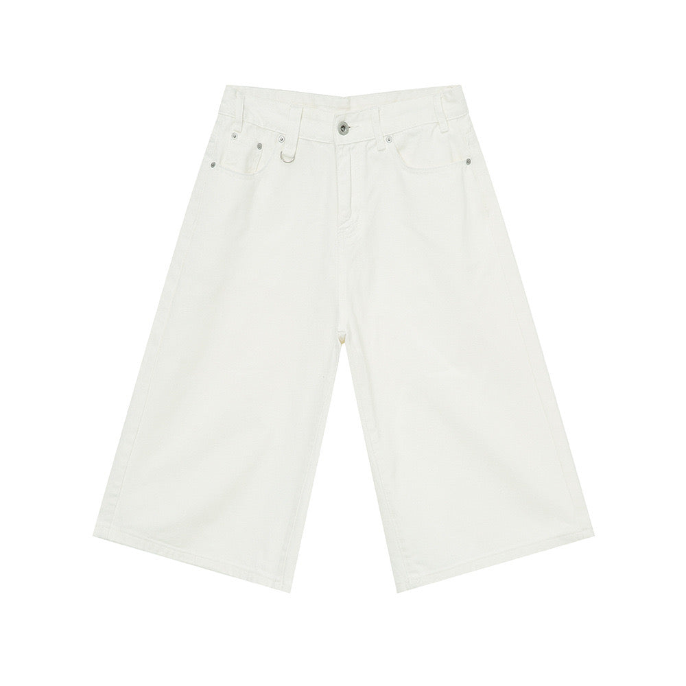 Flat lay of white wide-leg knee-length denim shorts with five-pocket construction and button closure