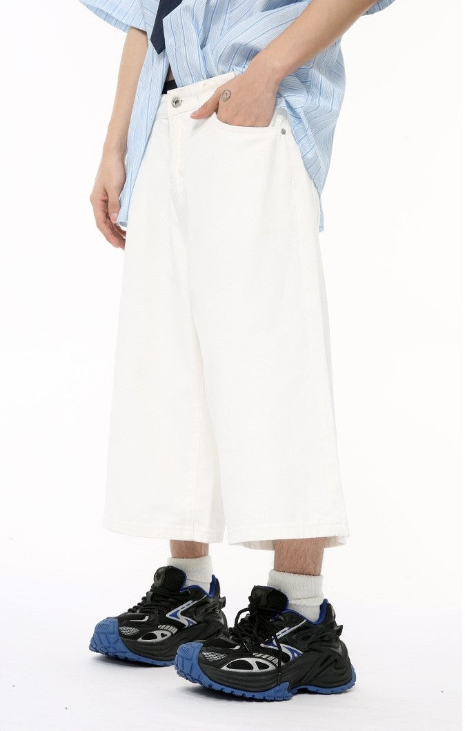 White wide-leg denim shorts with side pocket and hem shown on model