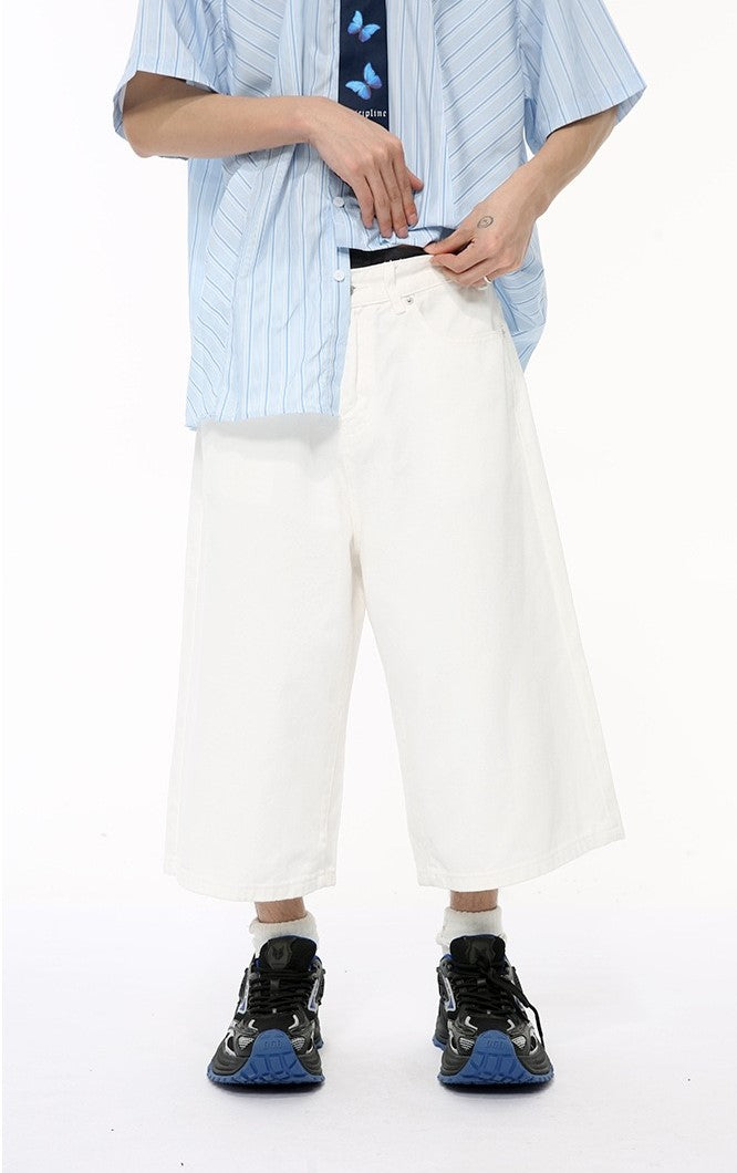 White wide-leg denim shorts worn with a light blue striped shirt, front view