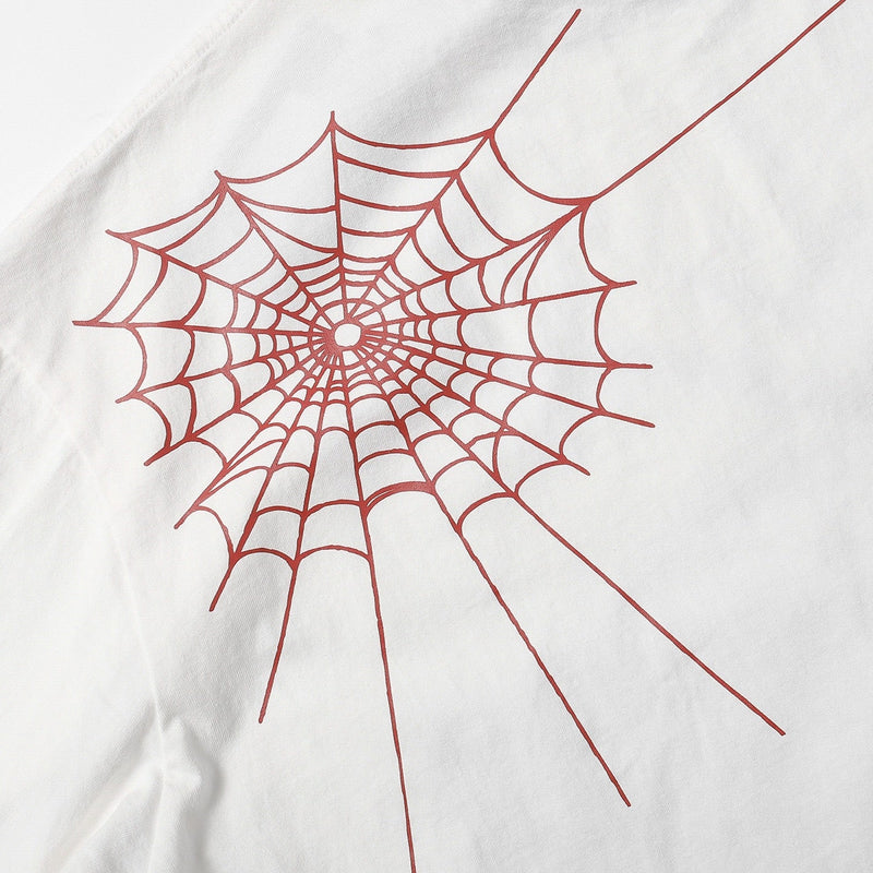 White oversized streetwear tee with a red spiderweb graphic print on the chest