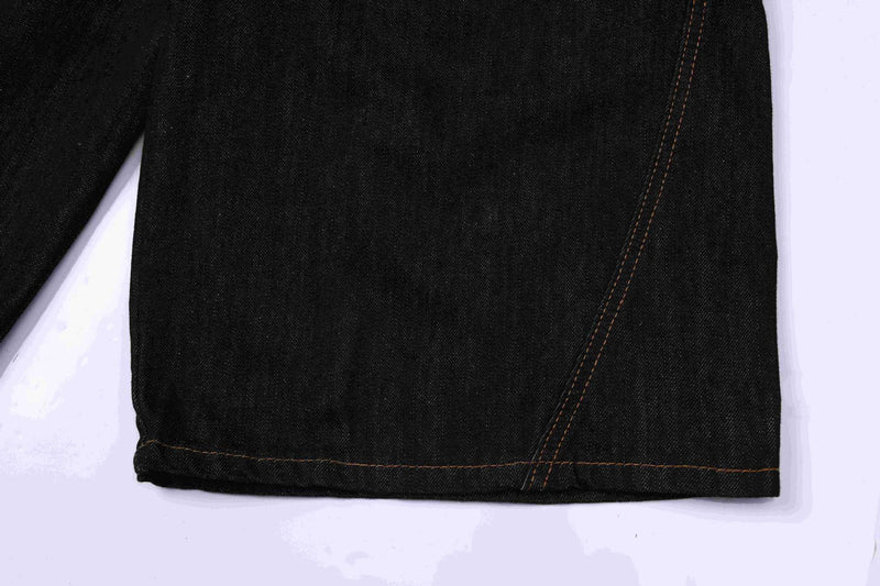 Close-up of dark indigo denim jorts hem and side seam stitching