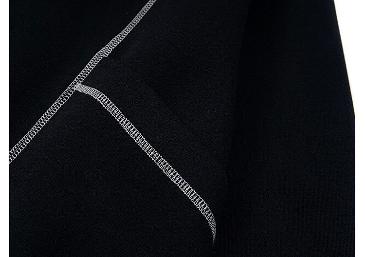 Close-up of black hoodie seam stitching with white contrast stitching