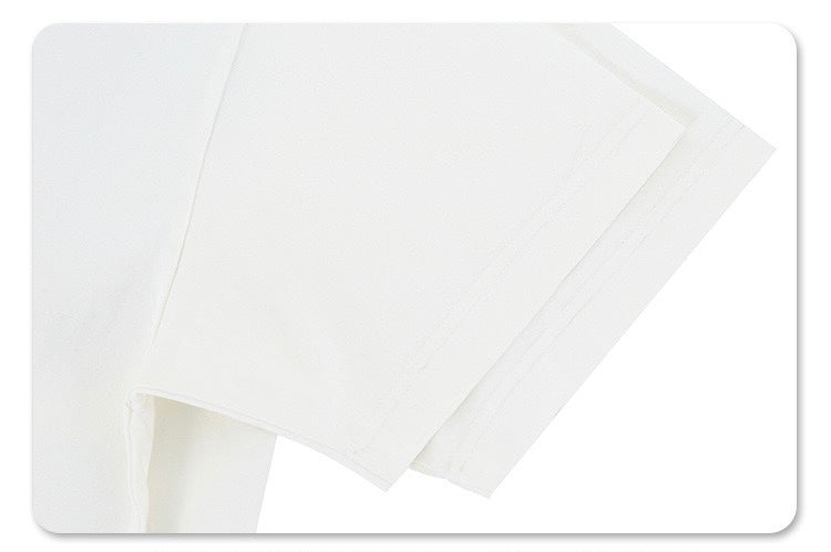 White oversized graphic tee sleeve detail with a clean relaxed streetwear fit and subtle stitched hem