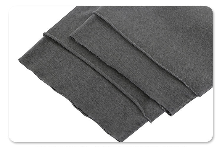Folded dark gray heavyweight cotton tee with vintage washed texture and split hem detailing