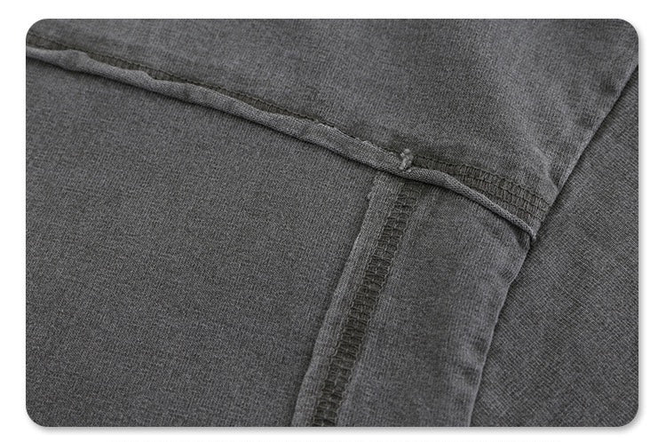 Close-up of a vintage washed gray heavyweight cotton tee with visible split hem and reinforced side seam stitching