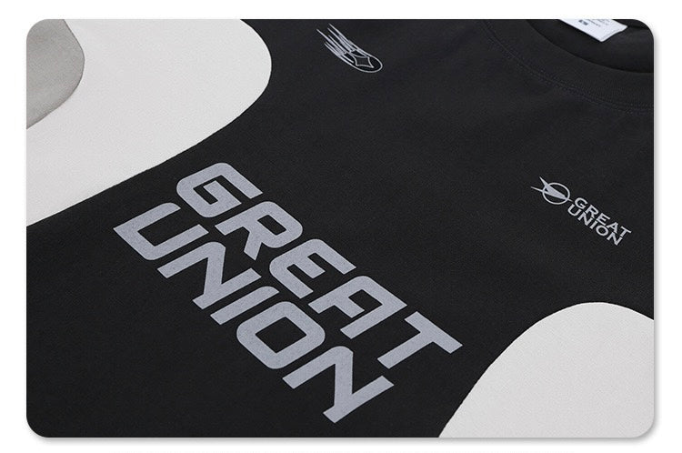Black Great Union colorblock T-shirt with bold silver logo and curved white panel accents, futuristic streetwear style