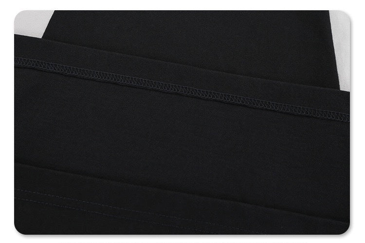 Black colorblock T-shirt with diagonal paneling and visible stitched seams for a sleek futuristic streetwear look