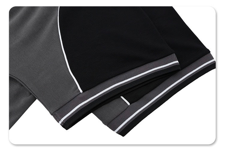 Close-up of black and gray retro polo tee sleeves with contrast piping and striped athletic cuff detail