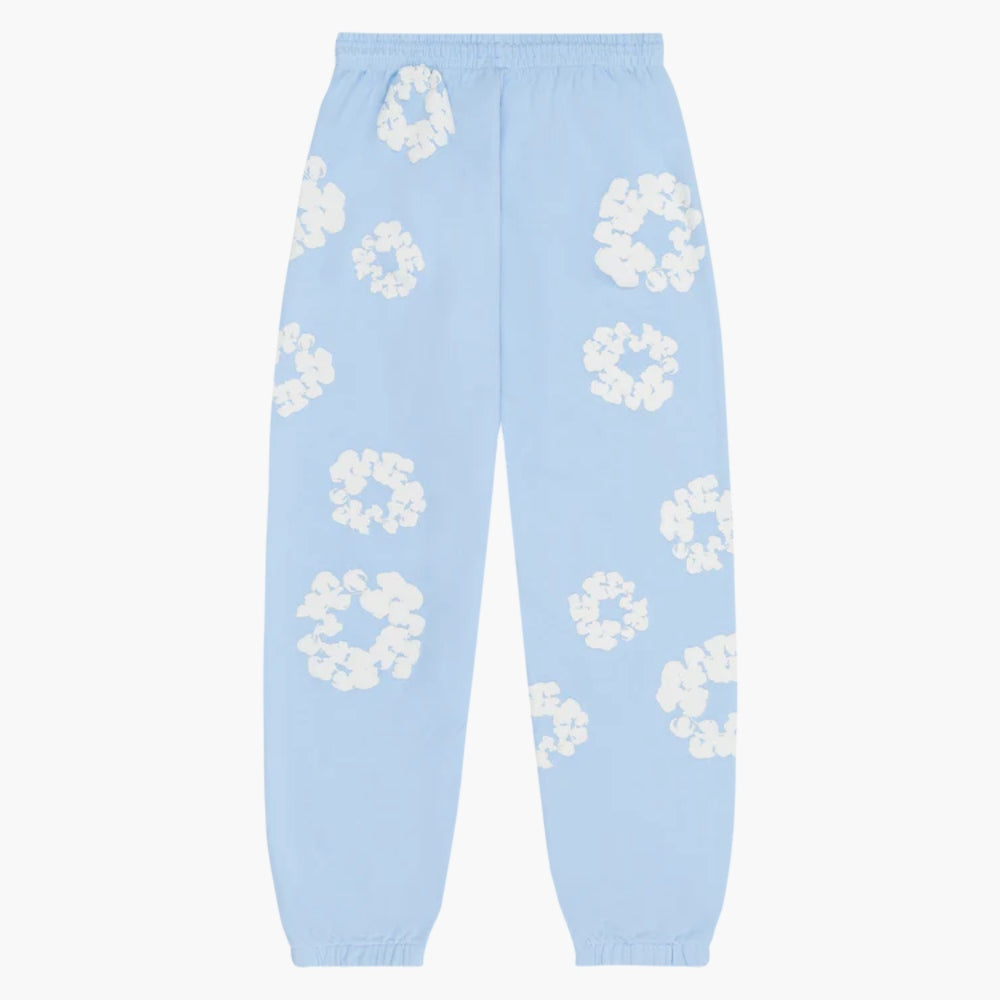 Light Blue “Cotton Wreath” Denim Tears Sweatpants feature an elastic waistband and cuffs with a white floral print inspired by the brand’s signature motif—perfect streetwear pants for a standout look.