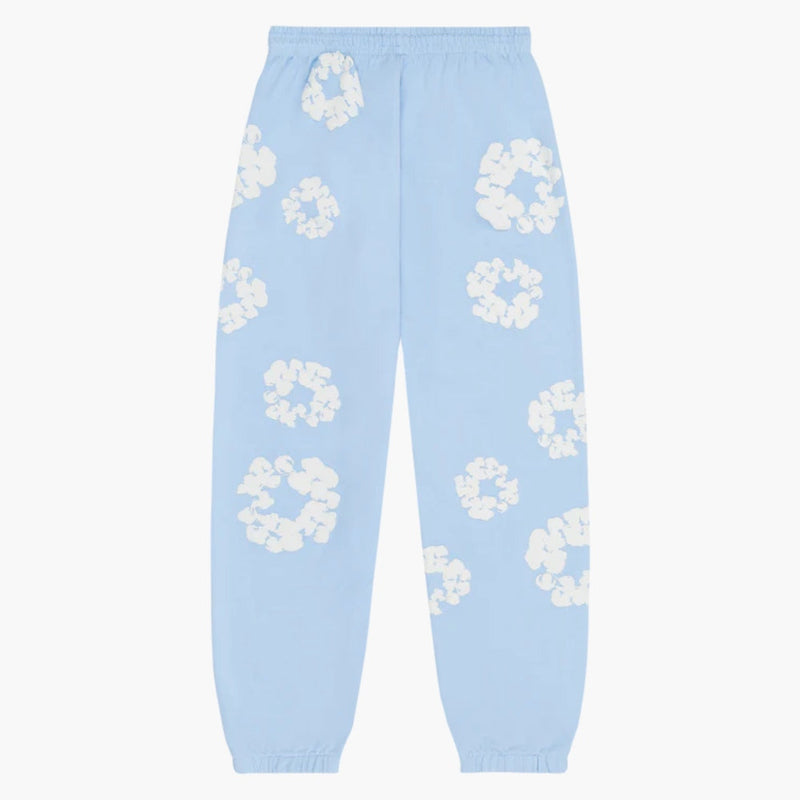 Light Blue “Cotton Wreath” Denim Tears Sweatpants feature an elastic waistband and cuffs with a white floral print inspired by the brand’s signature motif—perfect streetwear pants for a standout look.