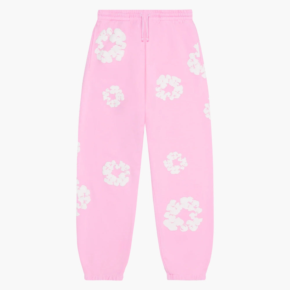 Pink “Cotton Wreath” Denim Tears Sweatpants feature an elastic waistband and cuffs, drawstring, and white floral print—an ideal choice for streetwear fans seeking a standout look inspired by classic Denim Tears style.