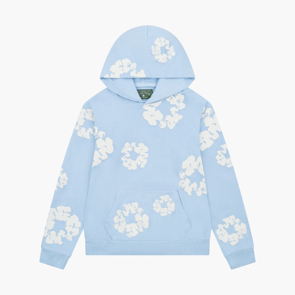 Light Blue Denim Tears Hoodie – White Cotton, featuring a front pocket, hood, and white cotton wreath pattern on light blue fabric. The hoodie is displayed flat on a plain white background.