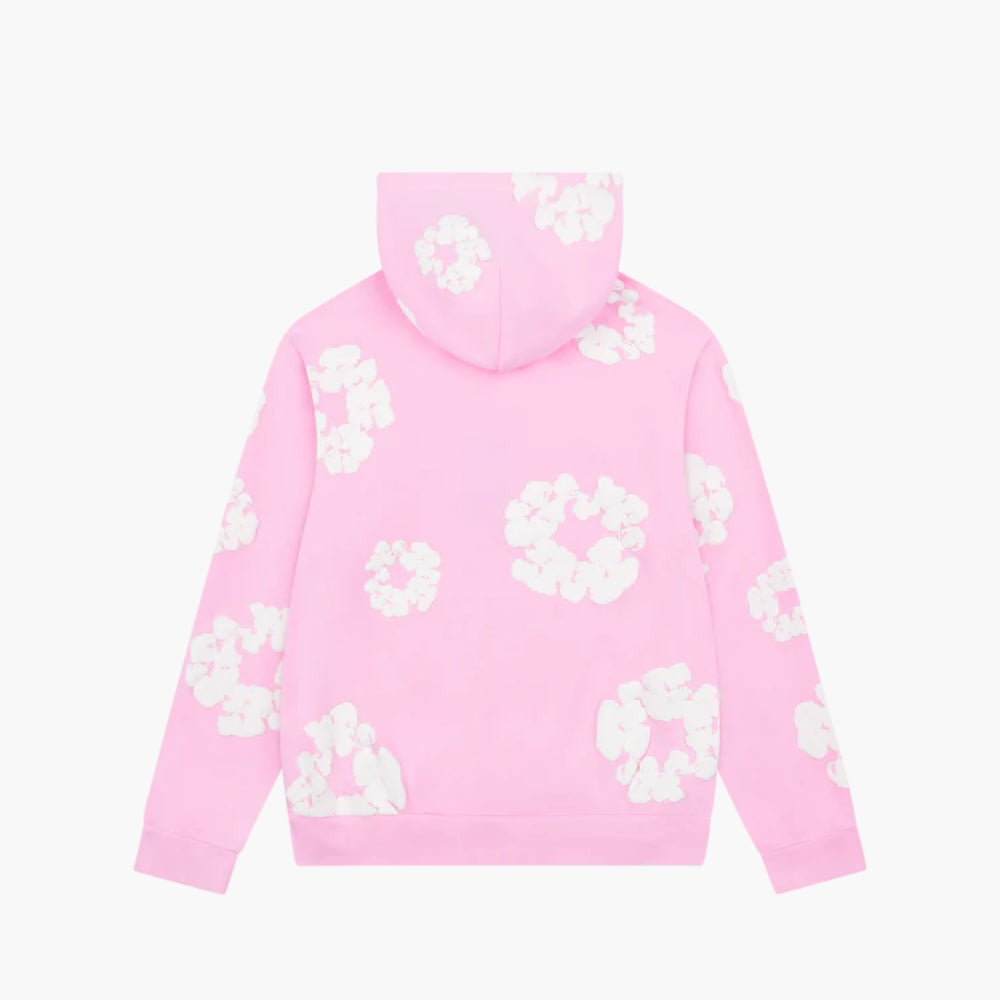 The Pink “Cotton Wreath” Denim Tears Hoodie is a light pink streetwear pullover with a hood, decorated with white floral prints on the back, sleeves, and hood. Displayed against a plain white background.