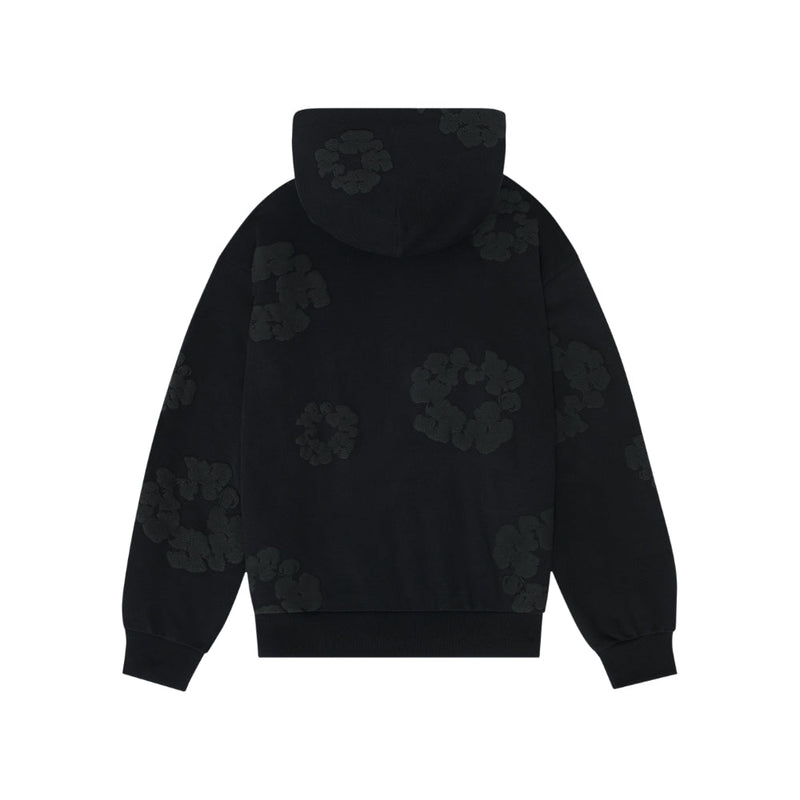 The Black Monochrome “Cotton Wreath” Denim Tears Hoodie is a minimal streetwear sweatshirt with a relaxed fit, dark floral or abstract circular patterns on the back, sleeves, and hood, plus ribbed cuffs and waistband for comfort.