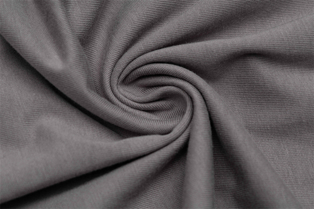 Close-up of gray knit fabric texture with soft folded T-shirt material