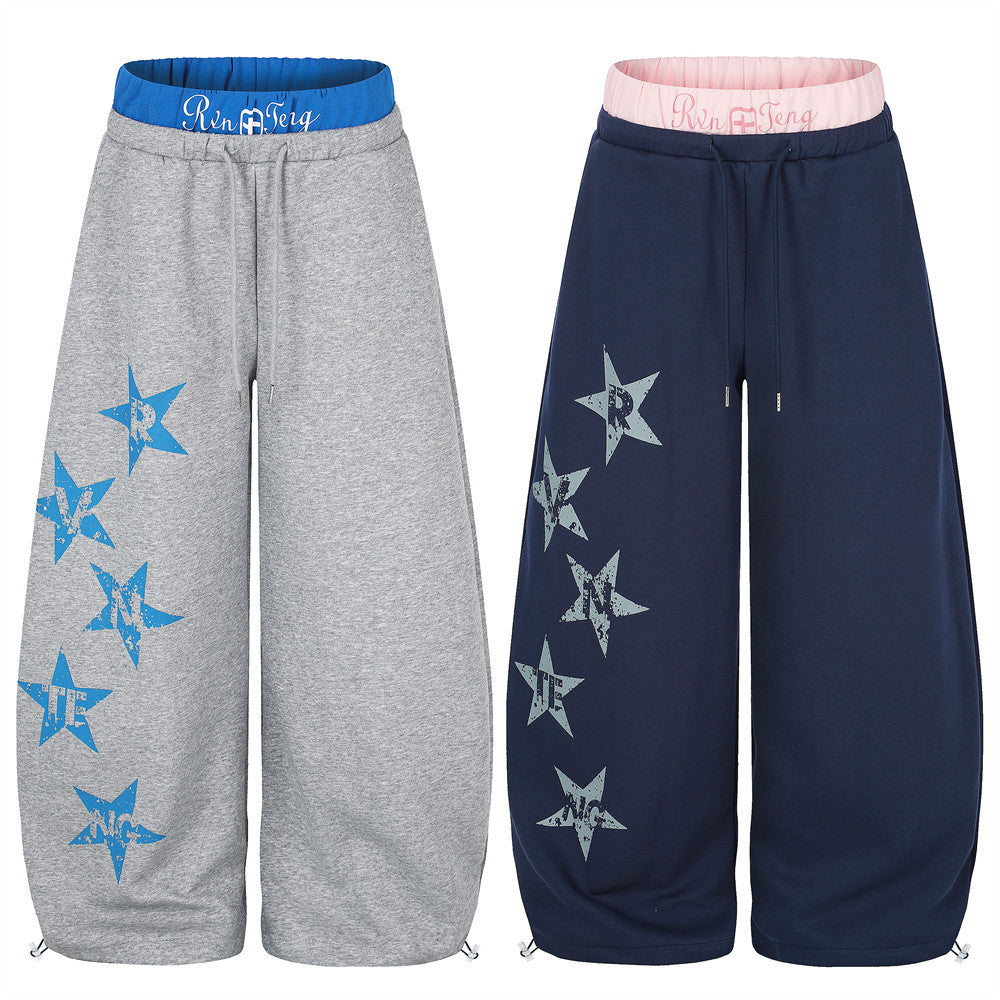 Wide-leg sweatpants in gray and navy, shown front view with blue and pink double waistbands