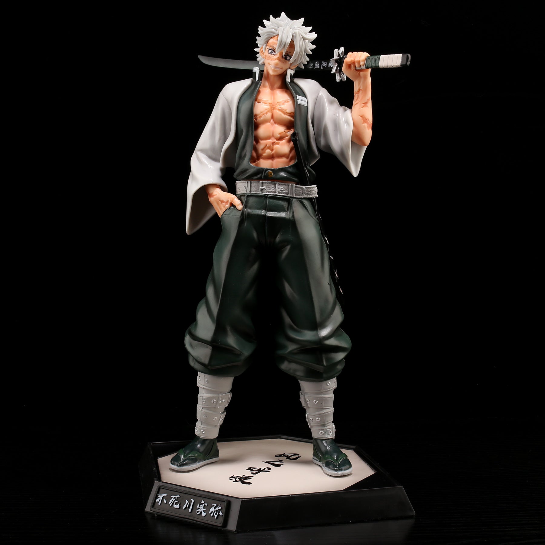 The Shinjuro Rengoku Demon Slayer PVC Figure, a 29cm high-quality collectible, portrays the silver-haired character in a striking black and white outfit with loose pants and bandaged legs, wielding a sword over the shoulder on a hexagonal base with Japanese text.