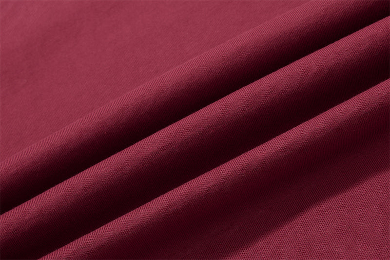 Close-up of burgundy shirt fabric with soft folded texture