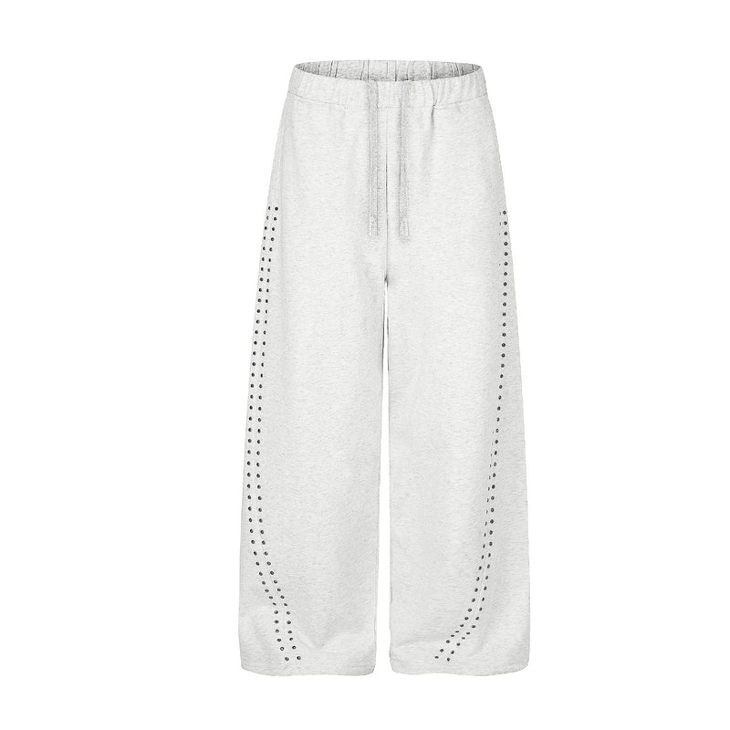 Pantalon de survêtement gris chiné coupe large, détails de clous strass courbés sur le devant des jambes et taille élastique à cordon
