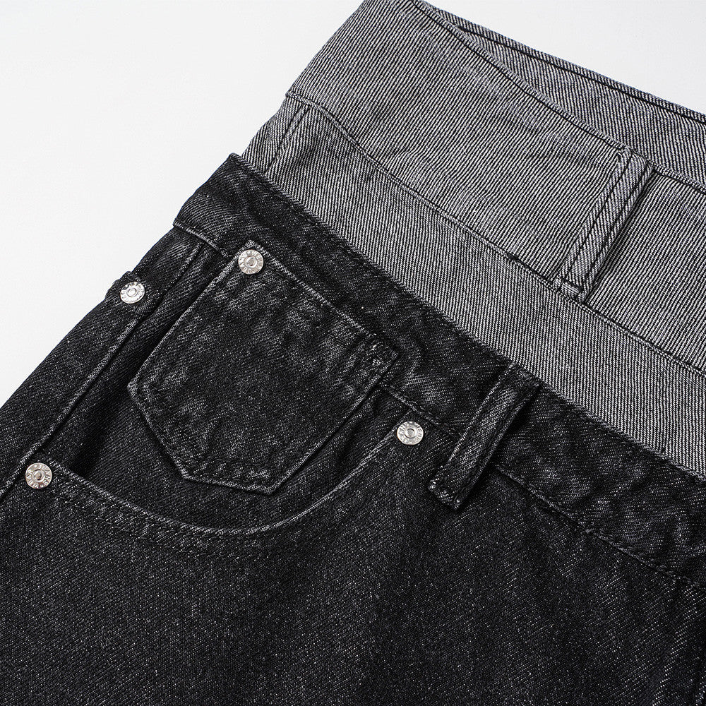 Close-up of black jeans back pocket and gray waistband detail