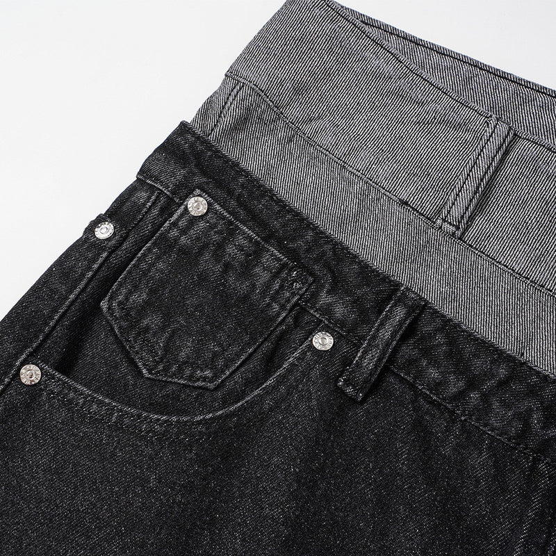 Close-up of black jeans back pocket and gray waistband detail