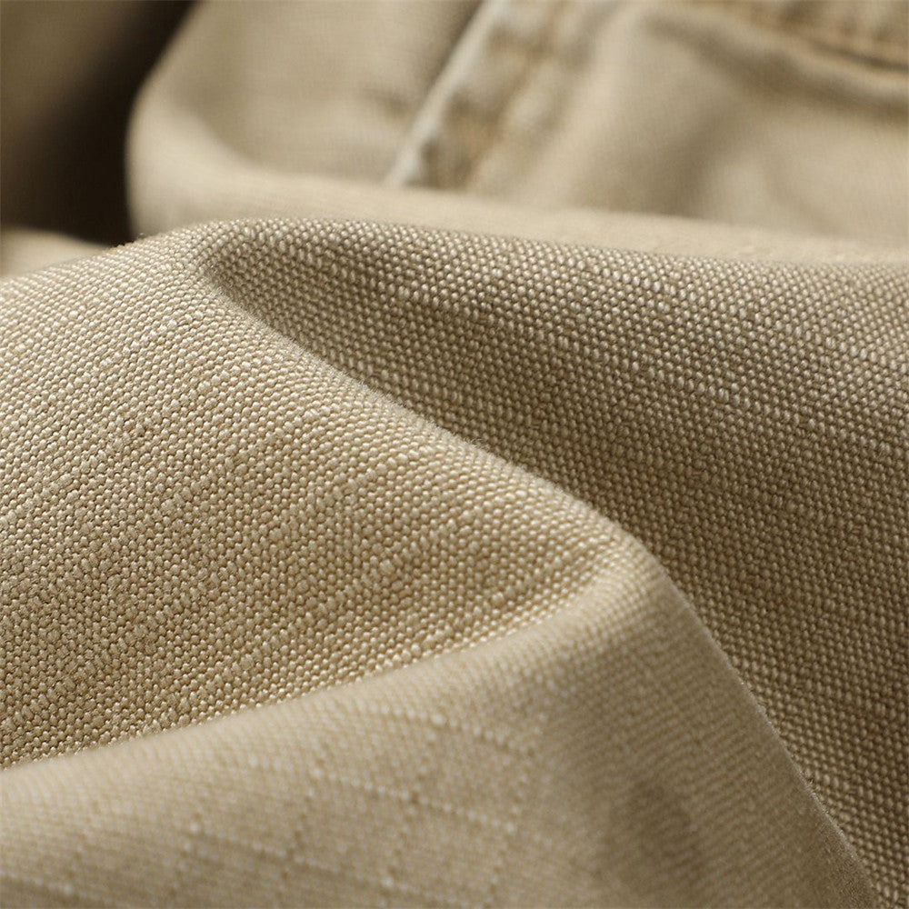 Close-up of khaki cotton cargo shorts fabric with textured weave and soft folds