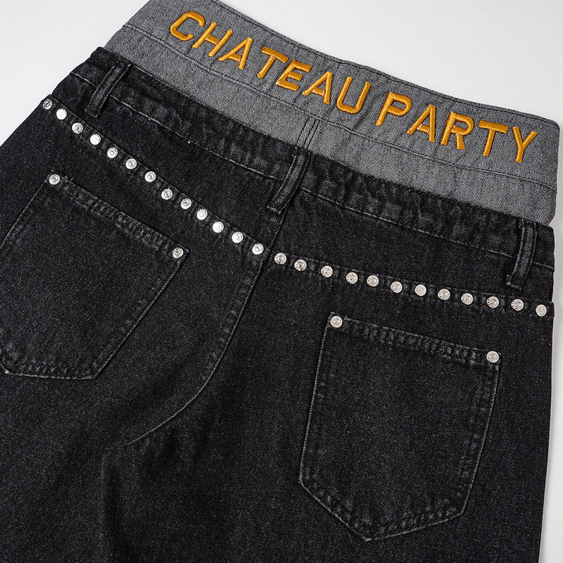 Back view of black jeans with gold CHATEAU PARTY embroidery and silver stud row