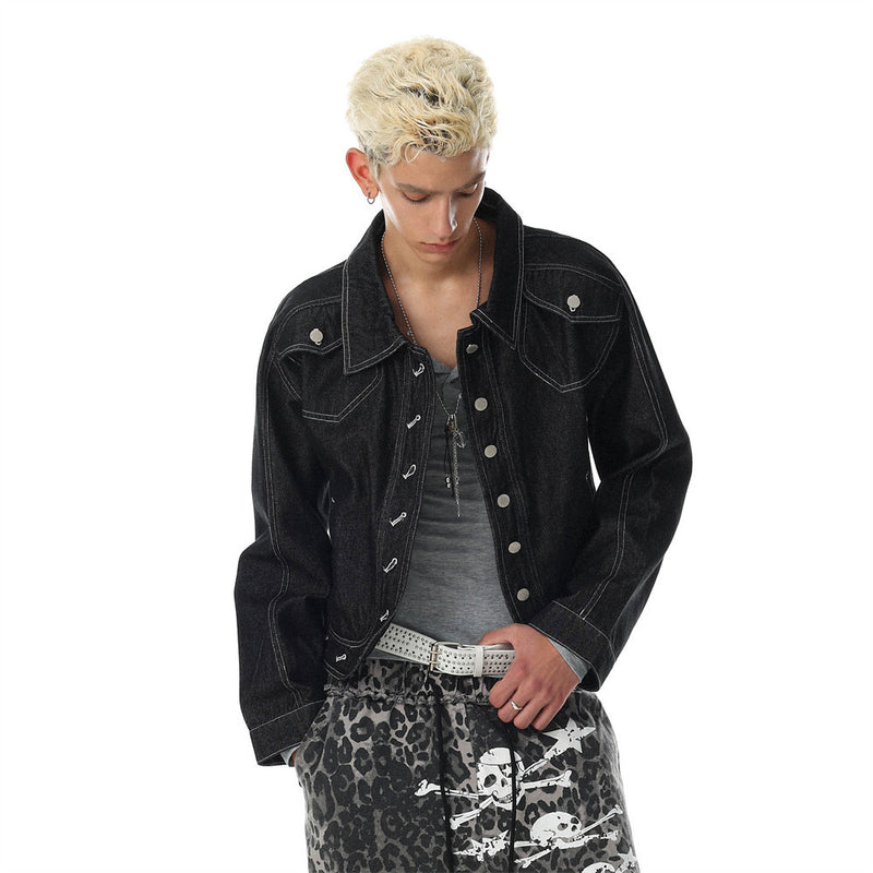Model wearing a black oversized denim jacket with snap buttons and contrast stitching