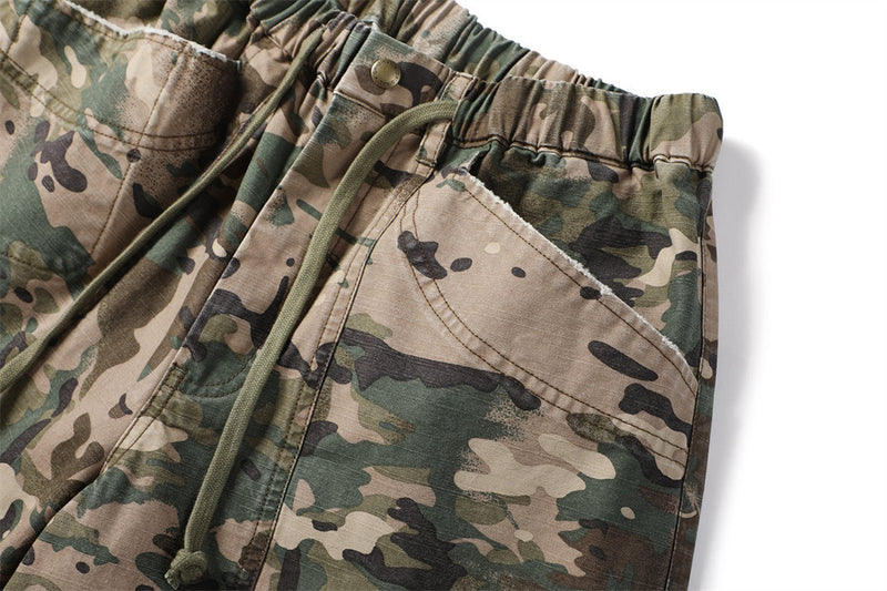 Close-up of camouflage shorts side pocket and drawstring on the front
