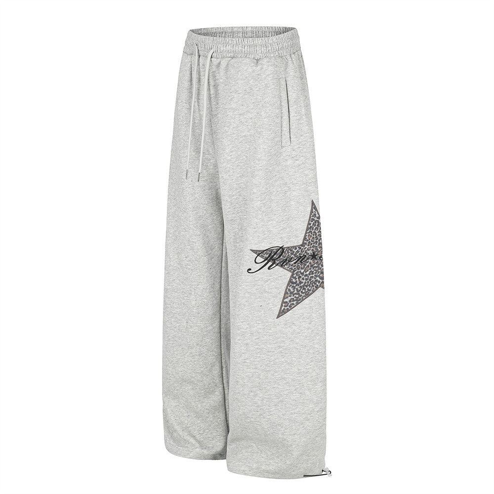Gray wide-leg sweatpants angled front view with leopard star patch on the leg