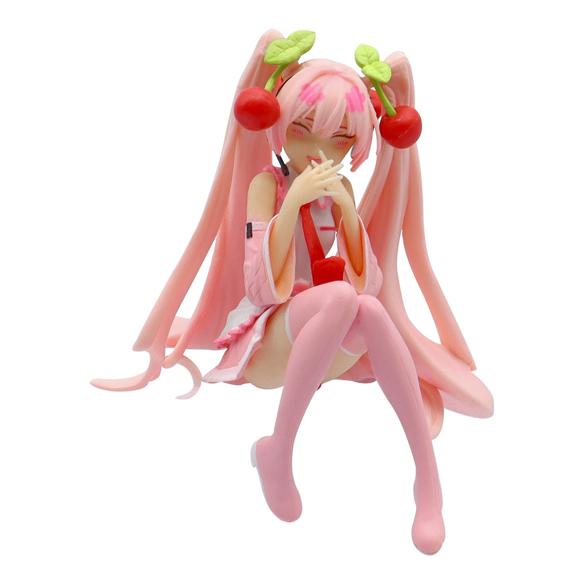 The 11cm PVC figure, &quot;Hatsune Miku Cherry Sitting Pose,&quot; shows an anime character with long pink pigtails decorated with cherries and green leaves. Wearing a pink outfit with long sleeves and thigh-high socks, the figure is playfully posed, hands near her face, with a smiling expression by Hatsune Miku.