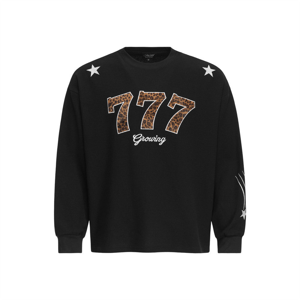 Men's black long sleeve waffle-knit crewneck t-shirt with leopard-print 777 appliqué and star patches
