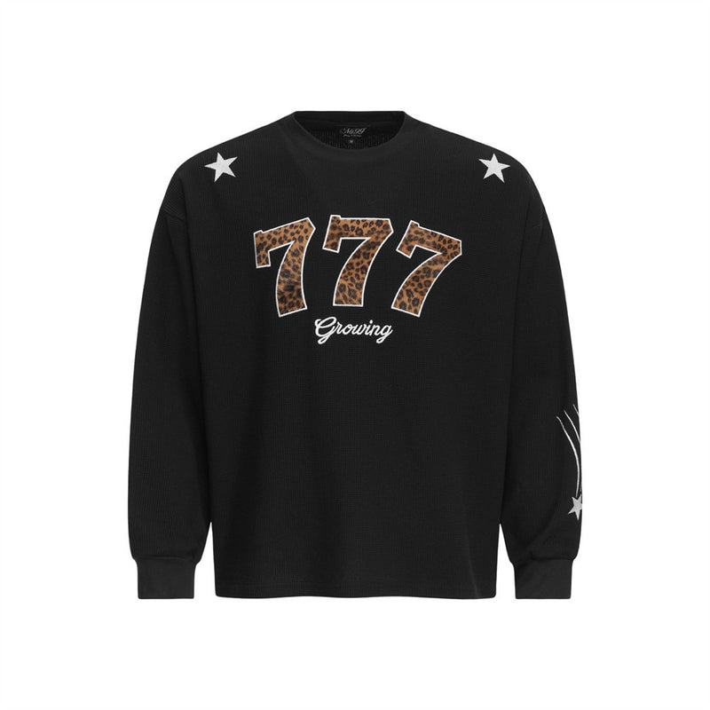 Men's black long sleeve waffle-knit crewneck t-shirt with leopard-print 777 appliqué and star patches