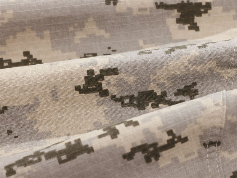 Close-up of desert digital camo fabric with stitched cargo pocket edge