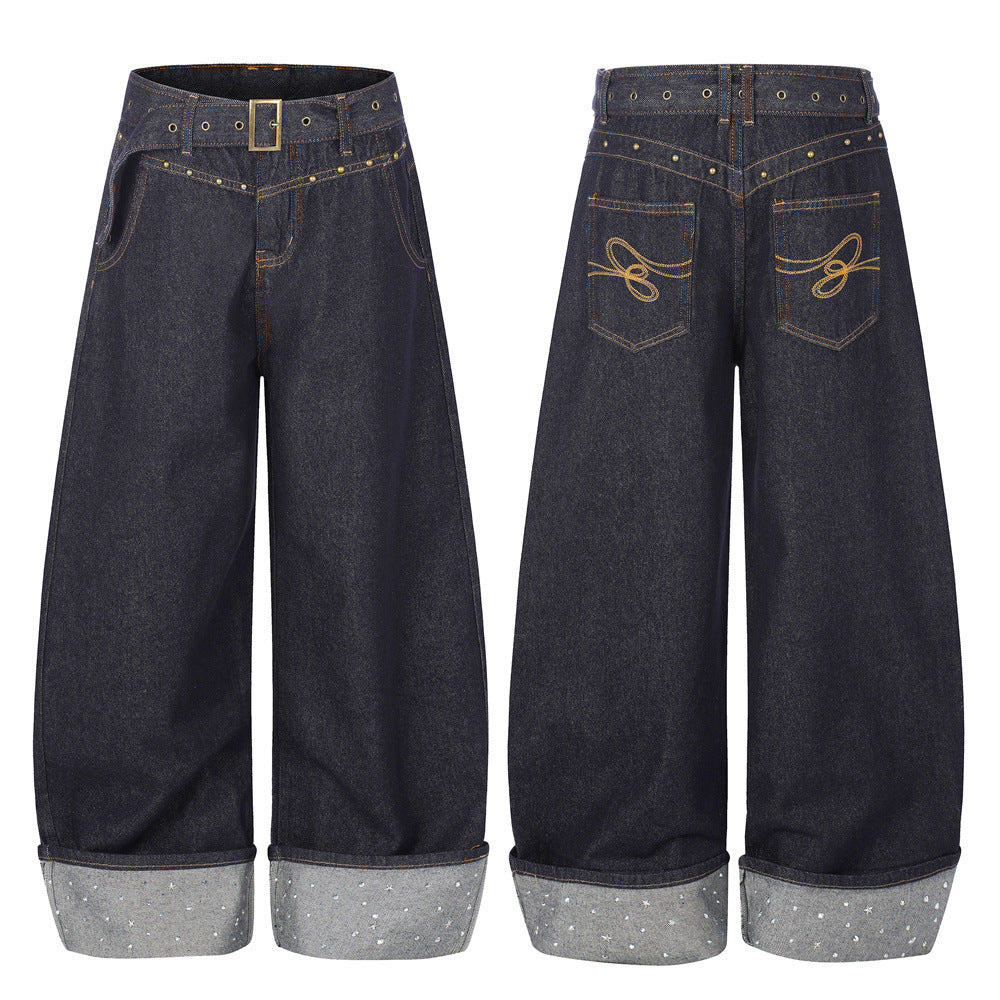 Oversized barrel wide leg indigo jeans with gold studded belt, embroidered back pockets and rhinestone star rolled cuffs, fro