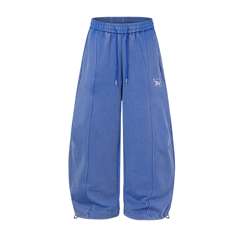 Oversized wide-leg acid wash sweatpants in blue with balloon silhouette, front seam detail, and drawstring hem