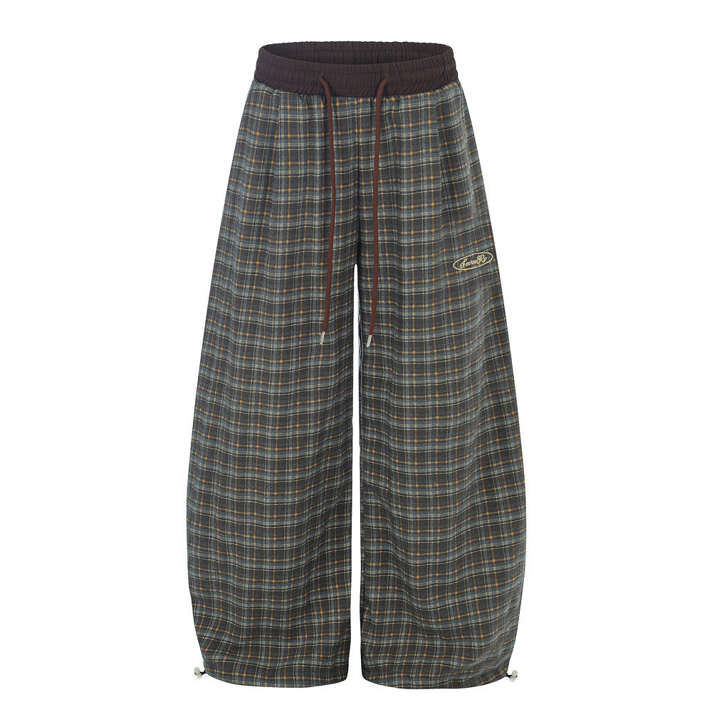 Oversized vintage plaid wide-leg baggy trousers with dark brown elastic waistband and drawstring, front and back view