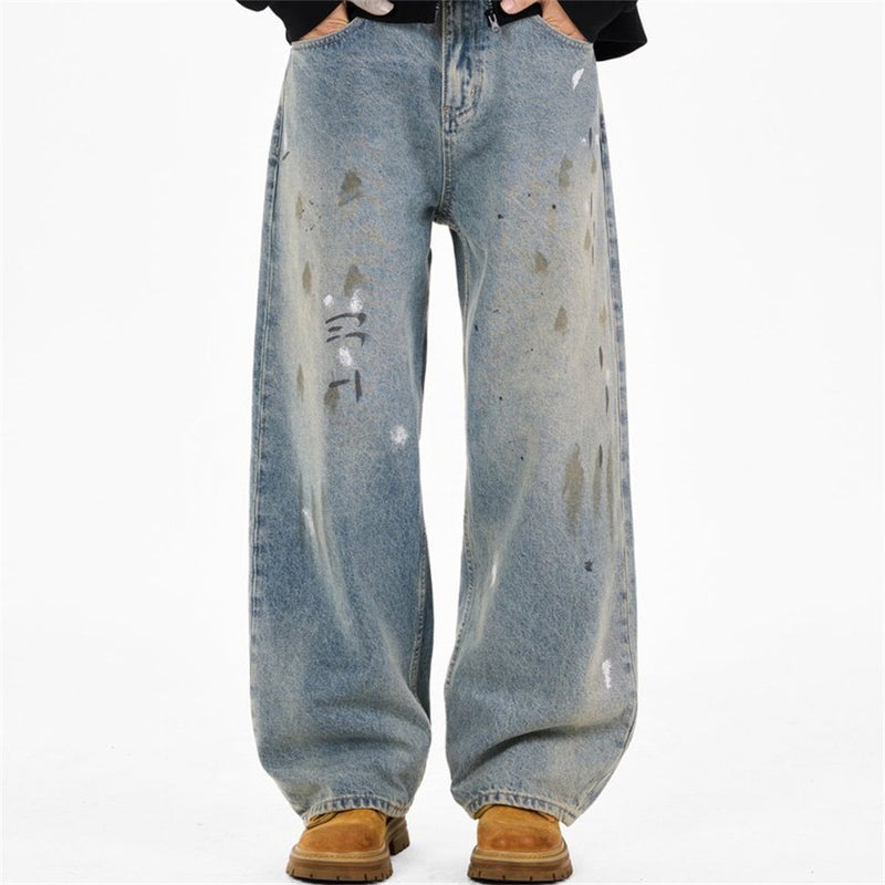 Front view of baggy light blue jeans with paint splatter marks and wide legs