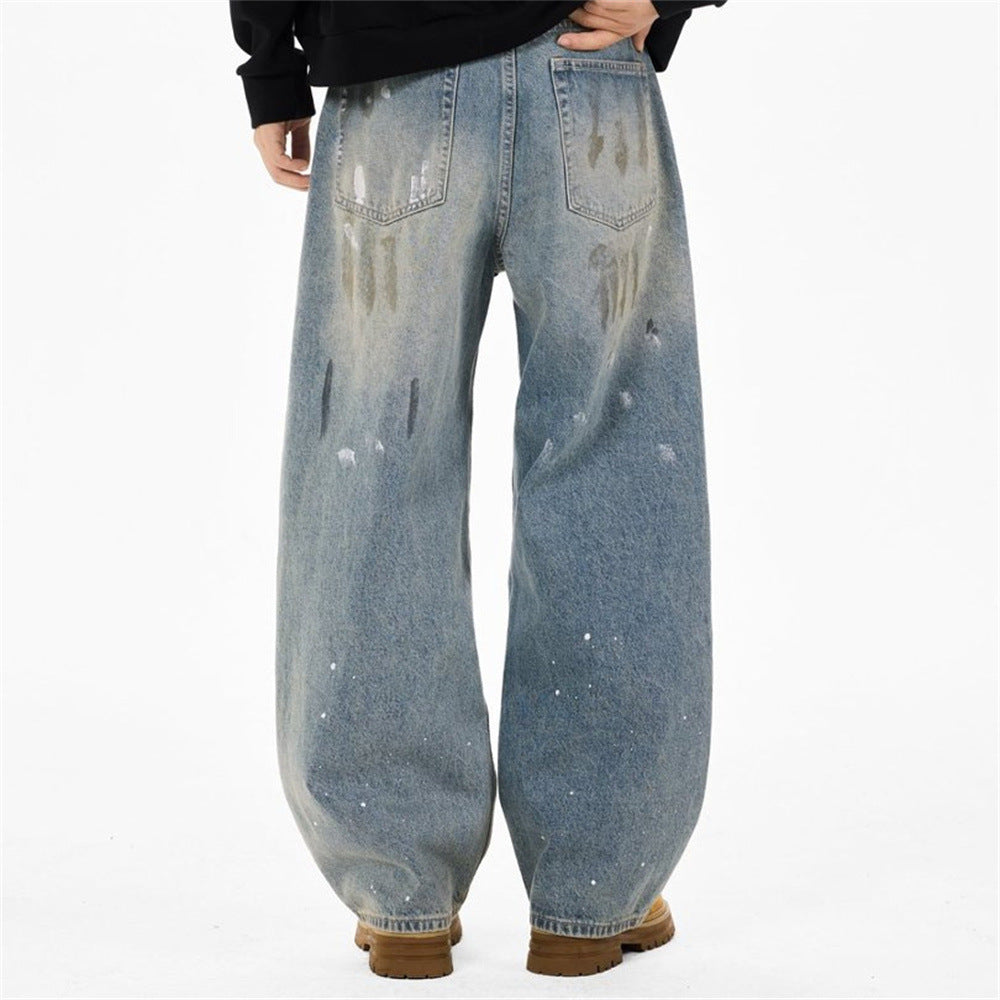 Back view of loose light wash jeans with paint splatter distressing and wide legs