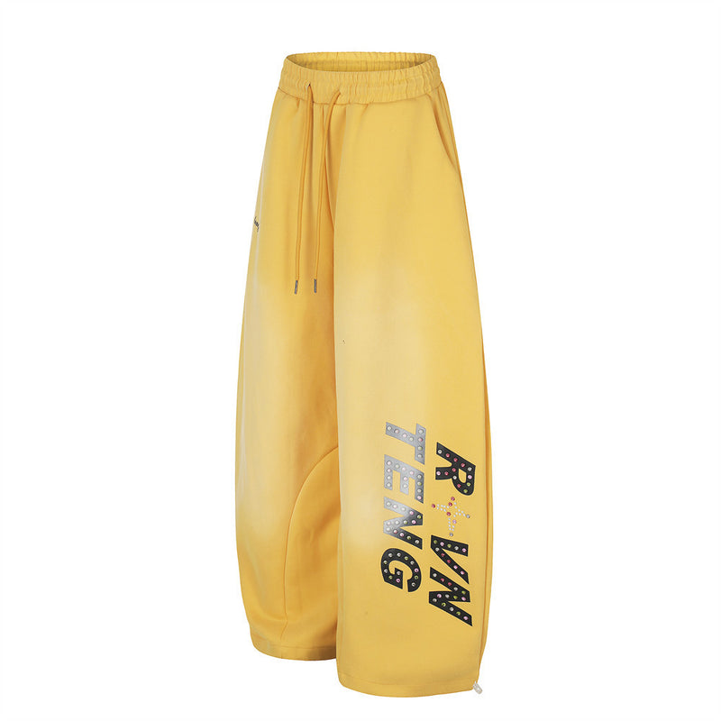 Yellow wide leg sweatpants, angled side view showing leg print