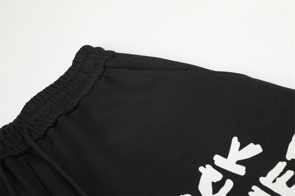 Pantalon de survêtement homme à jambes larges, motif graphique – Écusson licorne et slogan imprimé noir