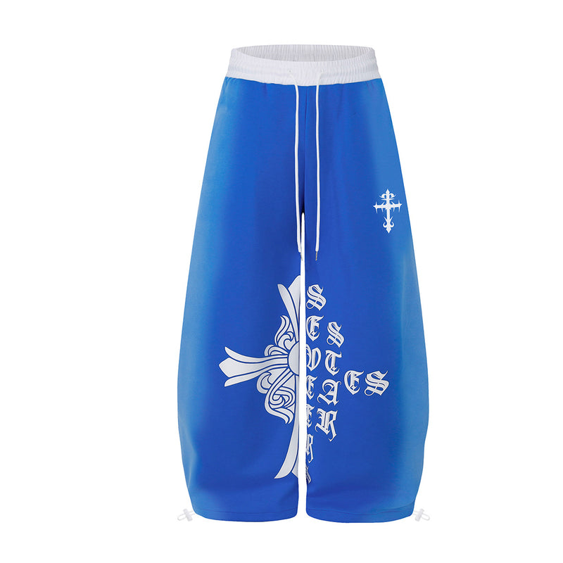Pantalón de chándal gótico extragrande de pierna ancha, en azul royal, con estampado gráfico blanco de letras góticas antiguas y cintura blanca en contraste