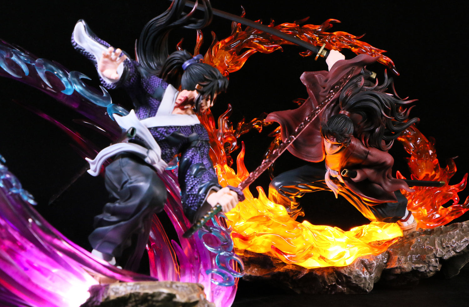 Two anime-style figurines in dynamic poses feature a Tsugikuni Yoriichi figure surrounded by purple and blue energy and wielding a sword with flame effects, emulating the Breath of the Sun technique. Both are set on a rocky base against a dark background. Product: Seakoff&